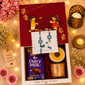 Thoughtful Rakhi Gift Hamper with Floral Candle, Coffee Candle, Premium Rakhi & Dairy Milk Chocolate